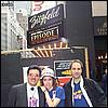 NYLine staffers, Robert, Suzanne, and Ariel, pose for a picture in front of newly installed marquee